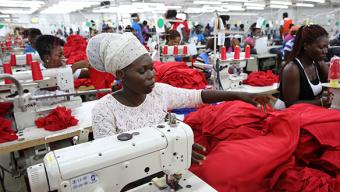 Dignity factory workers producing shirts
