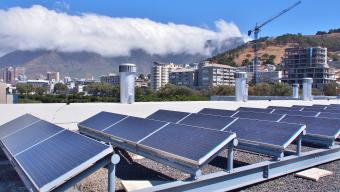 Solar panels or Solar cells on rooftop or terrace of building in Cape Town, South Africa. 